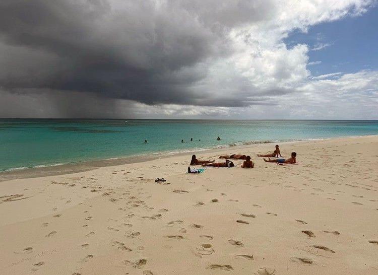 Clouds impinge on a beautiful beach day